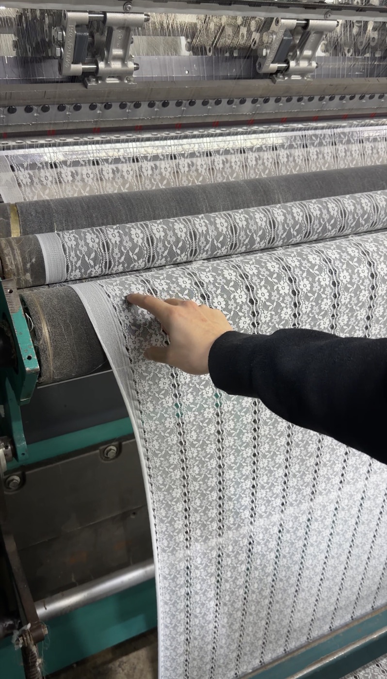Knitting machine producing lace fabric on the Ohzehn floor