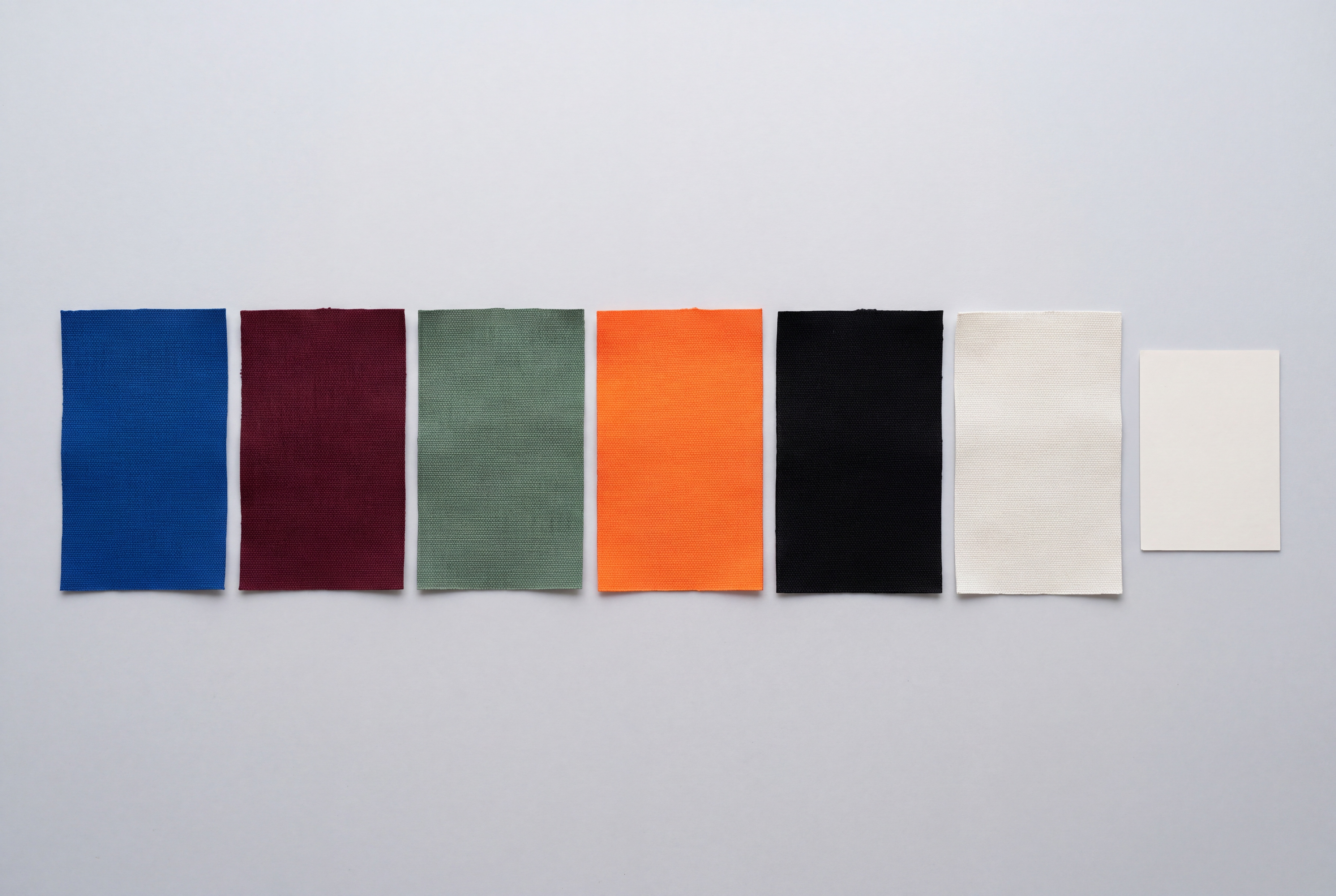 Row of lab-dip colour swatches beside a colour-standard card