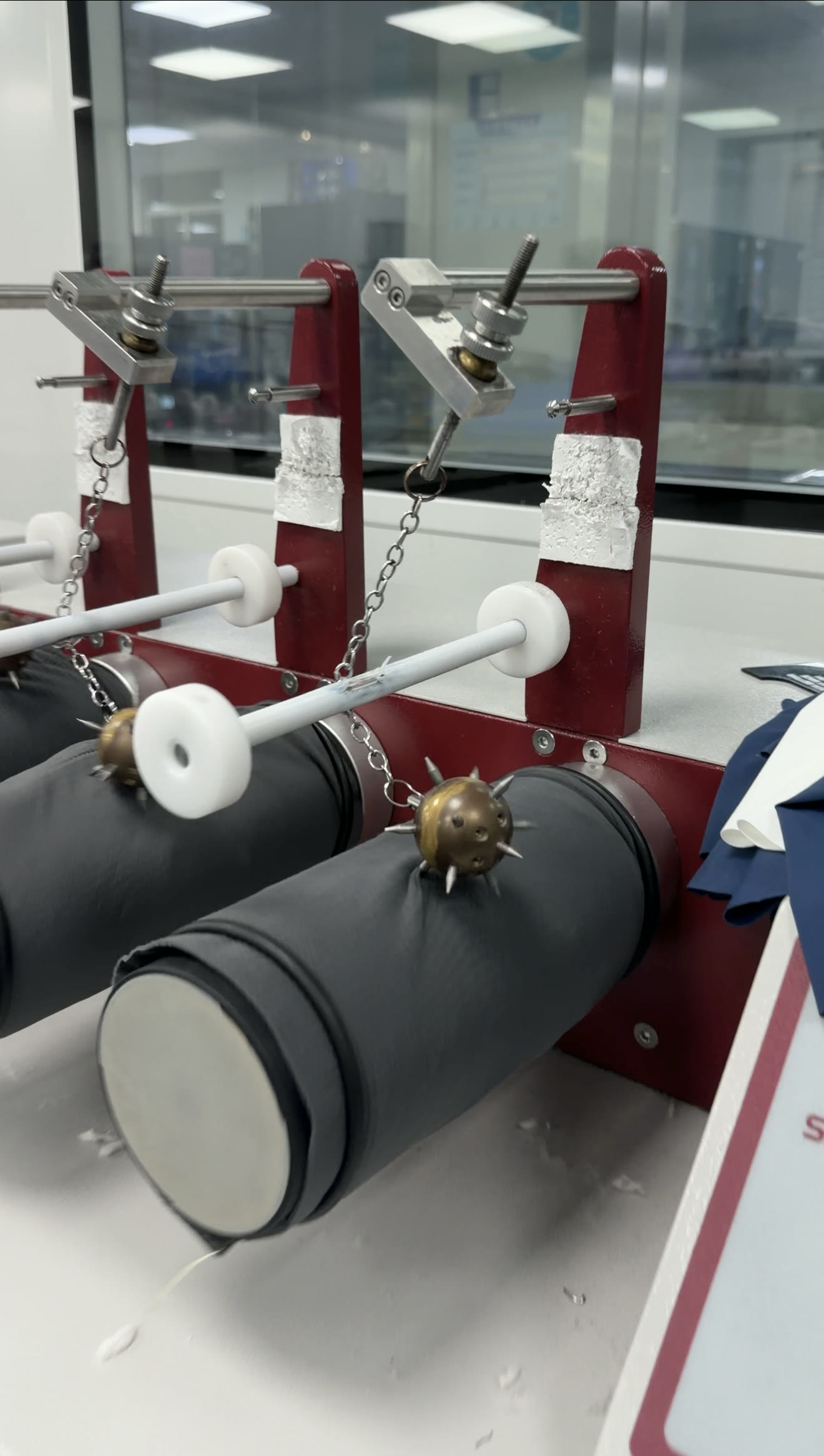 Spiked-ball abrasion and flex testers mounted on fabric-wrapped drums in our lab