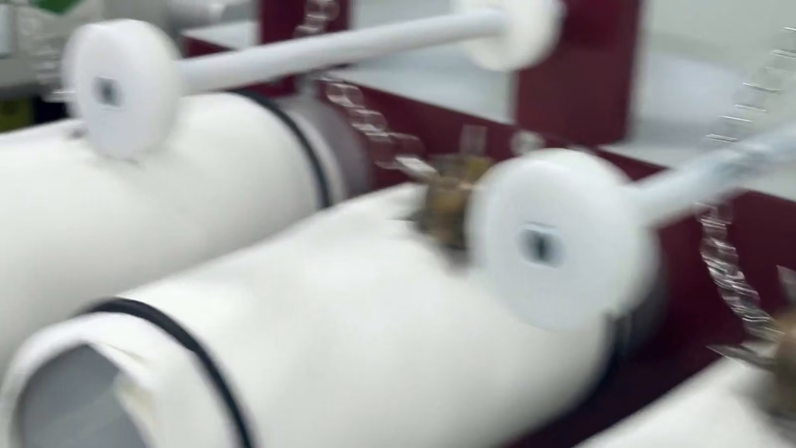 Fabric tubes turning on the rollers of a laboratory snag tester
